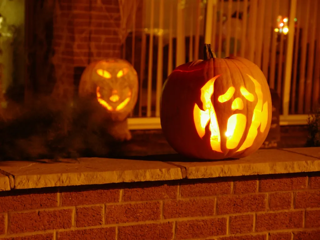 Carved jack-o'-lanterns glowing on a porch