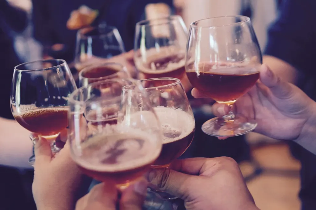 Friends raising glasses of beer at a bar